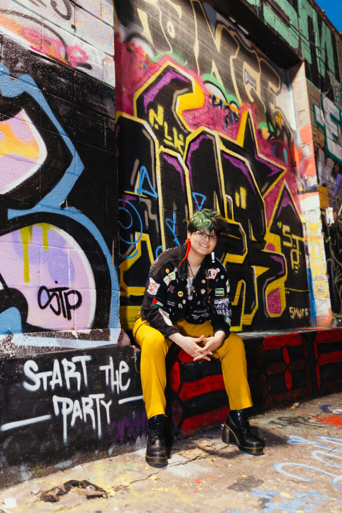 Kansas City unique senior session in the crossroads featuring graffitti and a colorful outfit