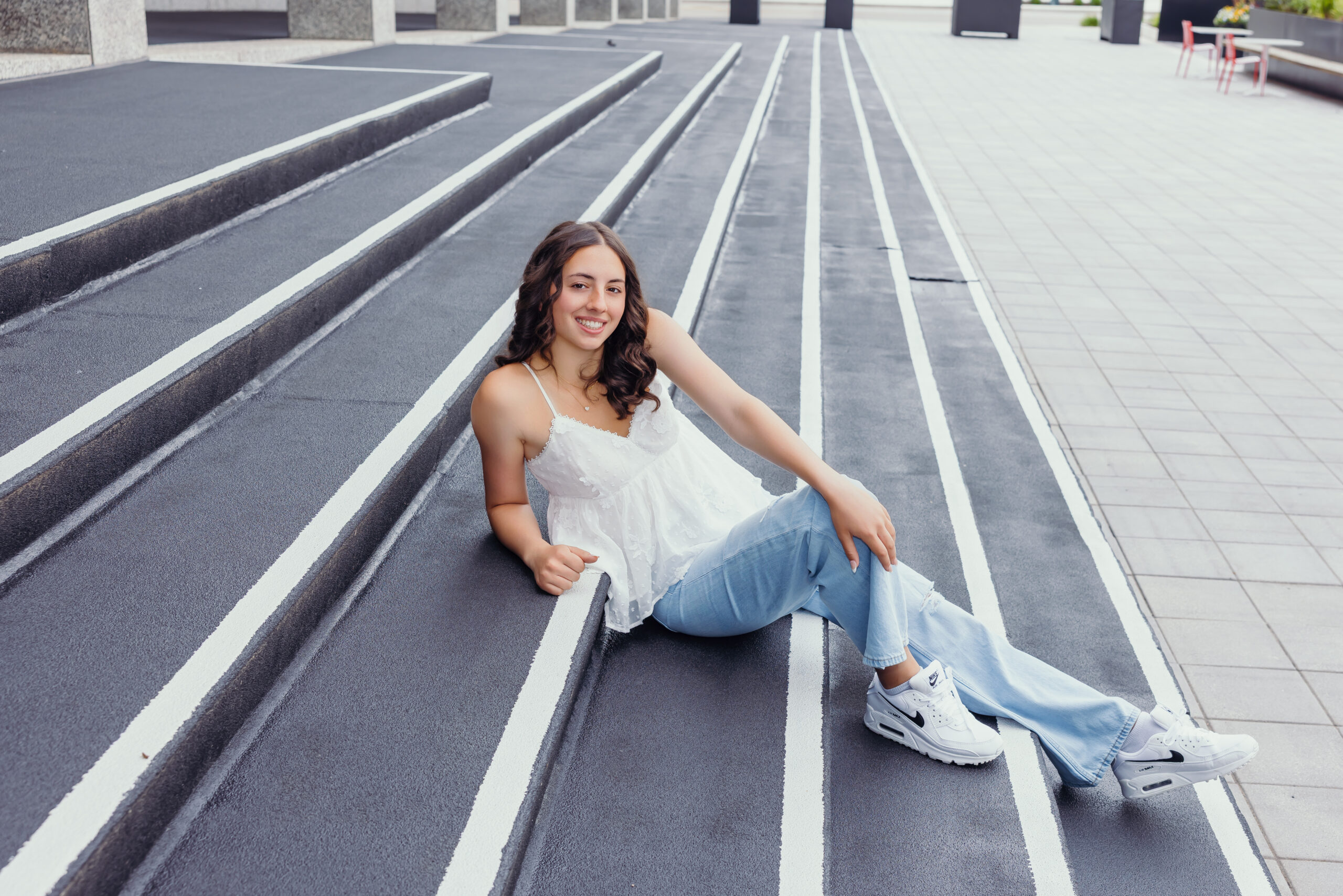 Senior posing in urban setting during high school senior photoshoot