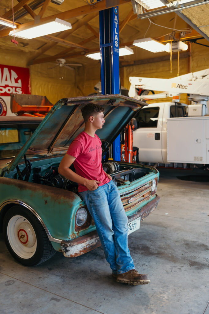 High school senior with vintage truck, hood up