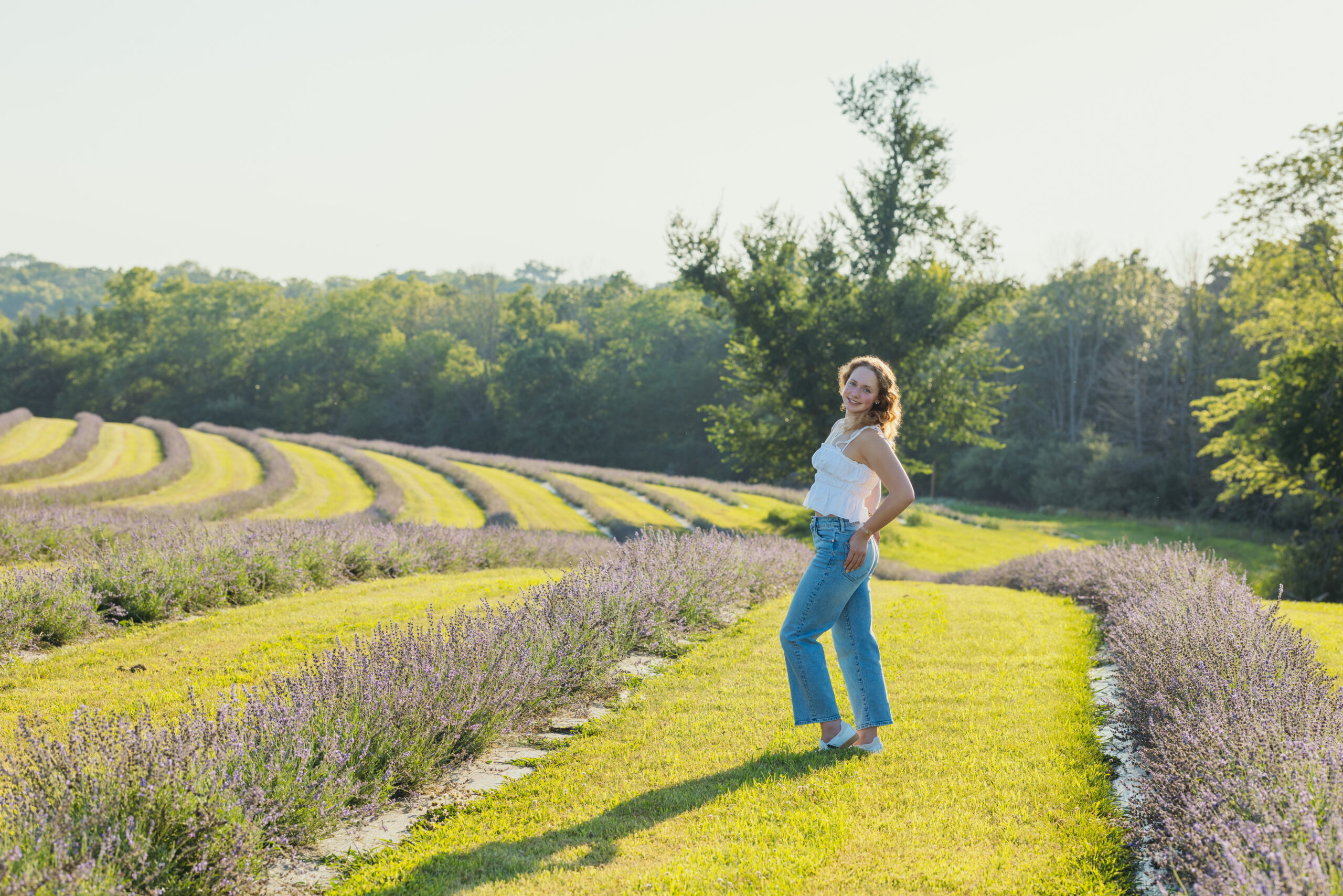 High school senior posing during golden hour at Pepperharrow Farms in lavender fields