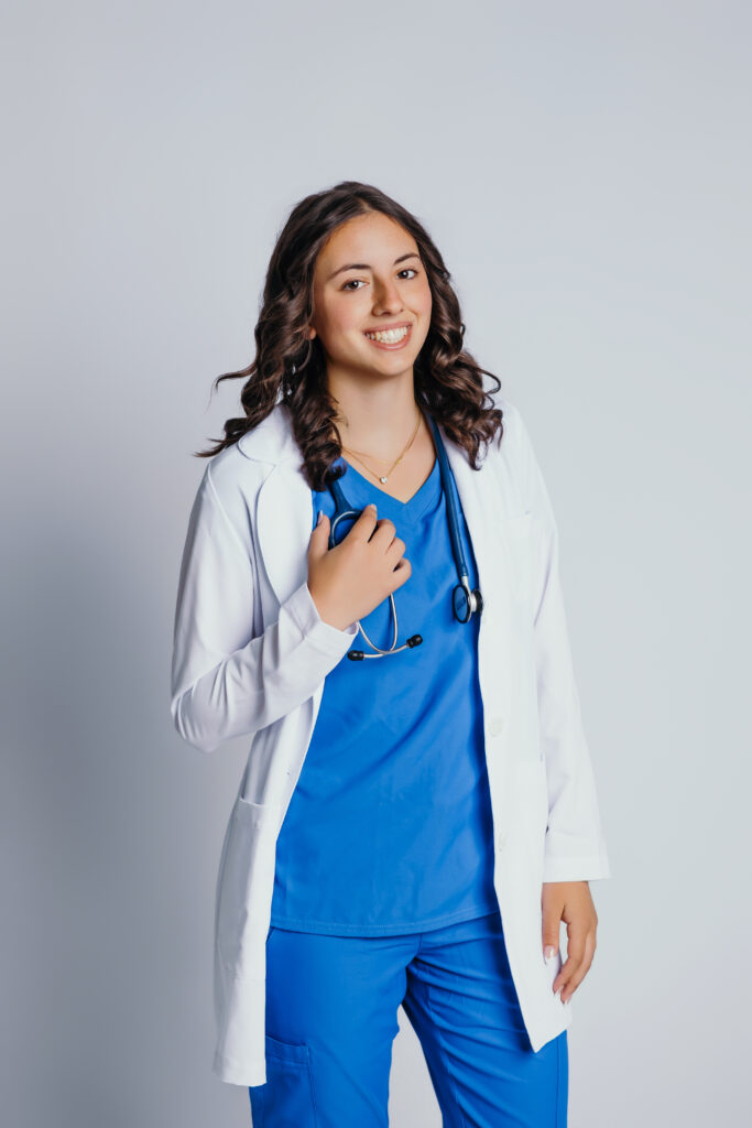 High school senior girl studio session in scrubs and white coat