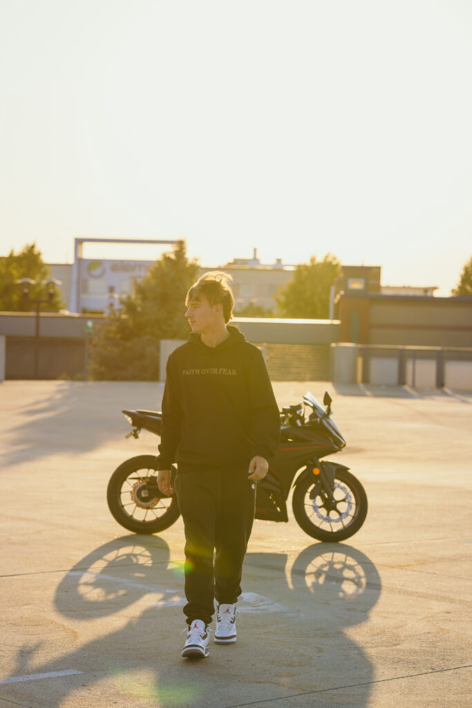 High school senior at golden hour with his motorcycle