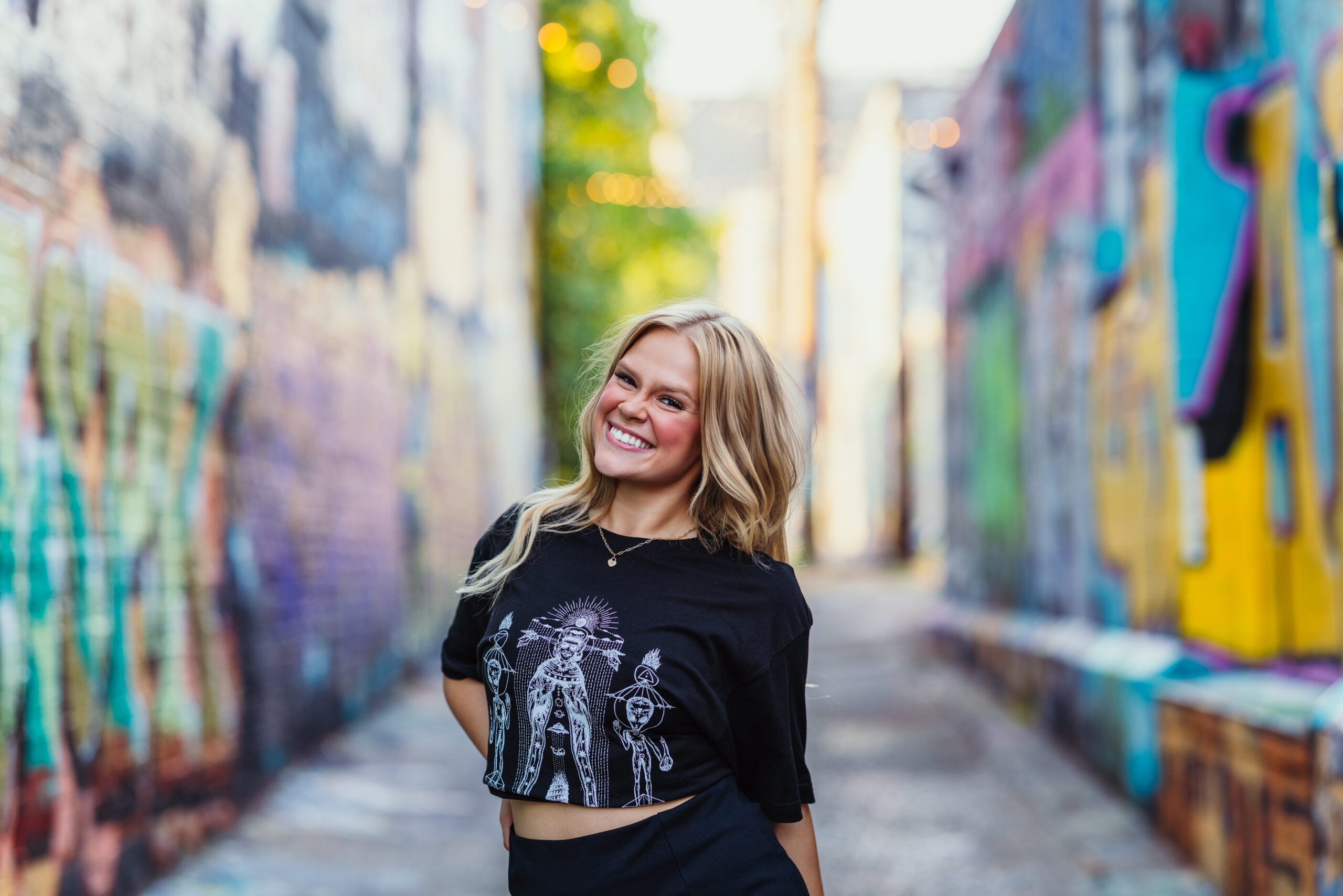 High school senior in downtown Kansas City Crossroads graffiti alley