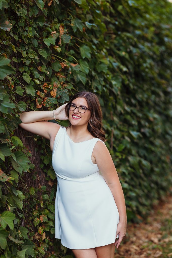 Kansas City senior photos against an ivy-covered urban wall