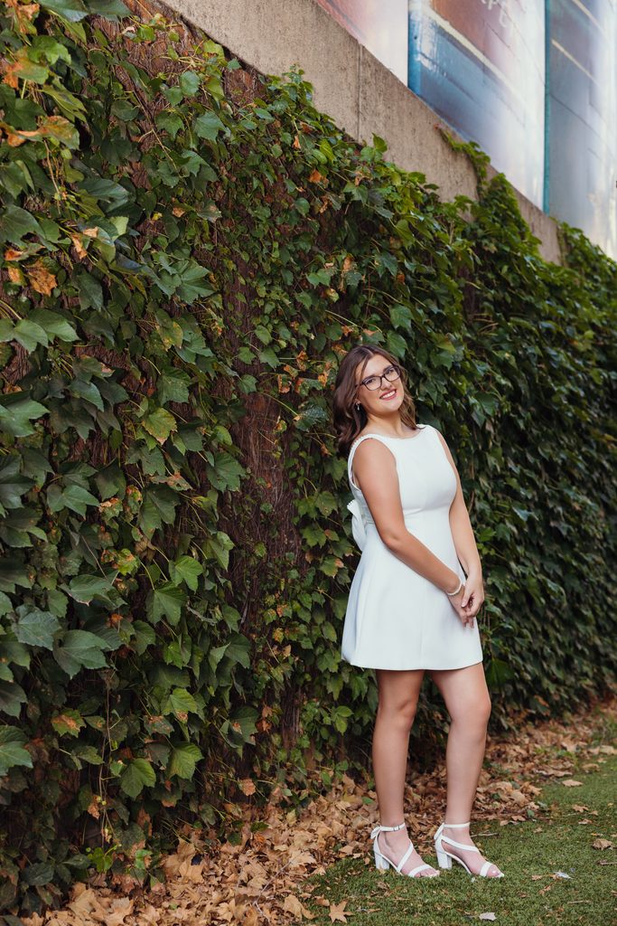 Kansas City senior photos against an ivy-covered urban wall