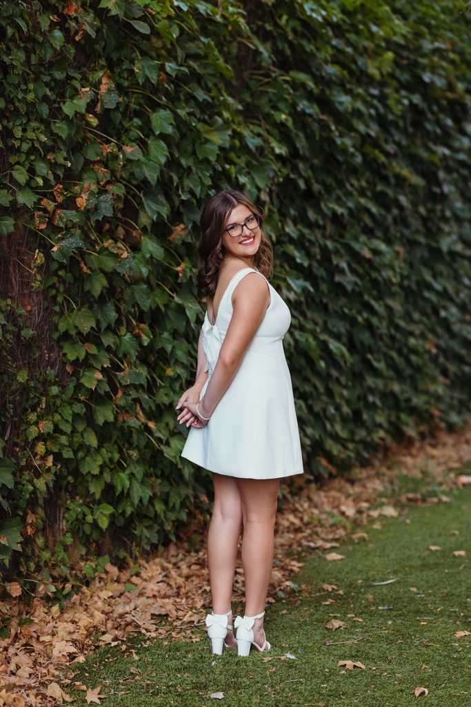 Kansas City senior photos against an ivy-covered urban wall