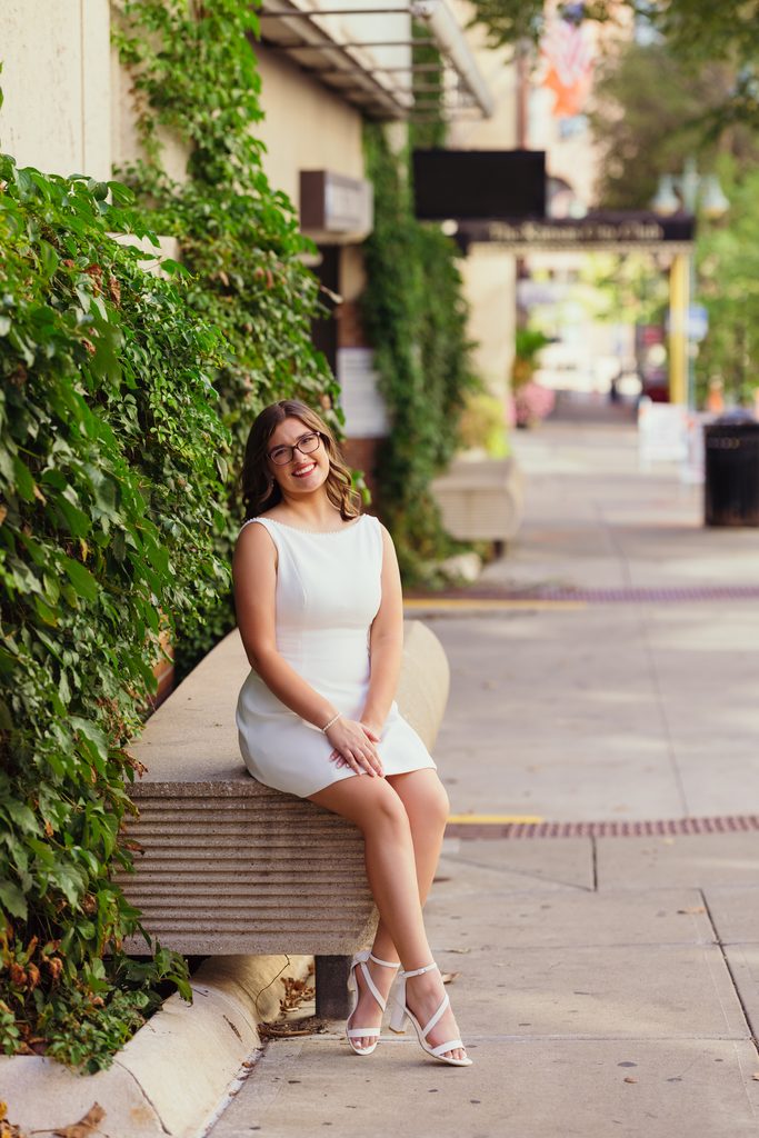 Kansas City senior photos against an ivy-covered urban wall