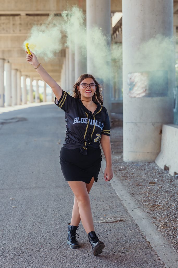 Creative Kansas City senior pictures with colorful smoke in the West Bottoms