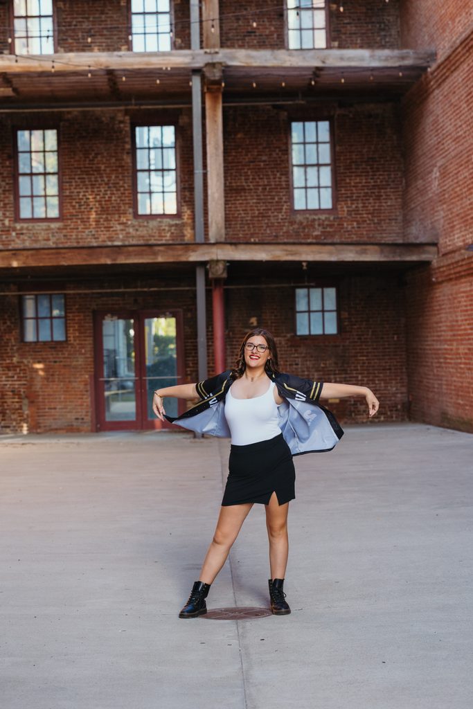Edgy West Bottoms senior portraits in front of urban brick building