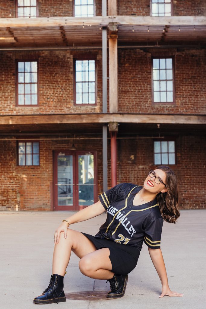 Edgy West Bottoms senior portraits in front of urban brick building
