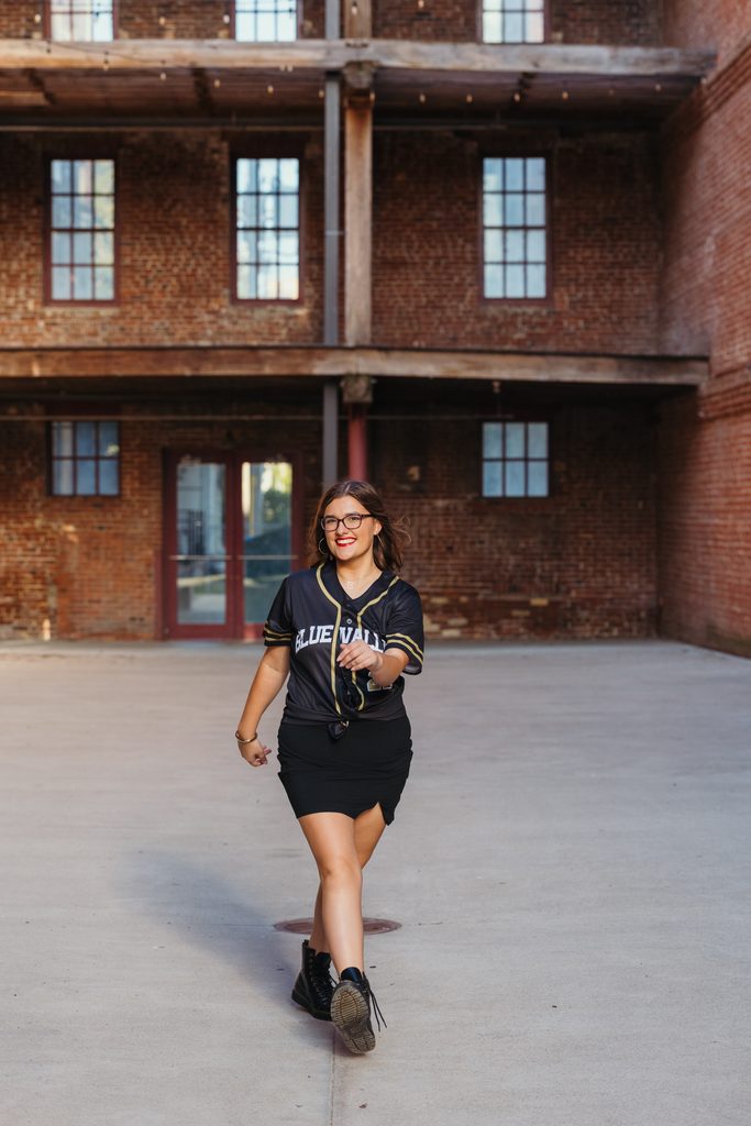 Edgy West Bottoms senior portraits in front of urban brick building