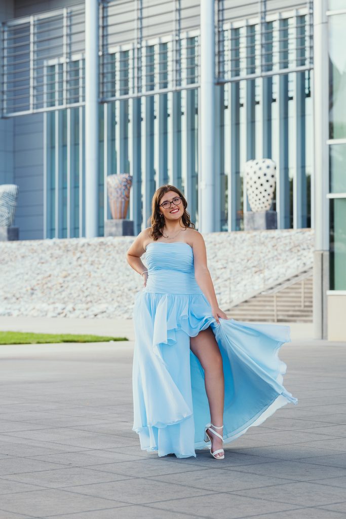 Kansas City senior portraits in a blue dress at the Kauffman Center for the Performing Arts