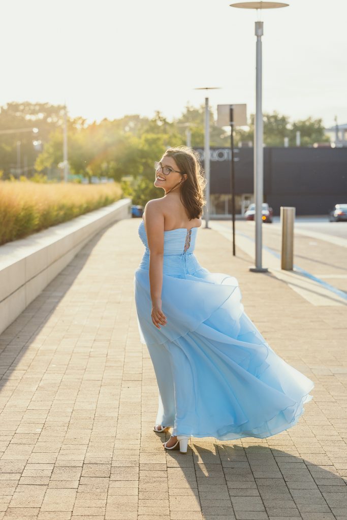 Kansas City senior portraits in a blue dress at the Kauffman Center for the Performing Arts